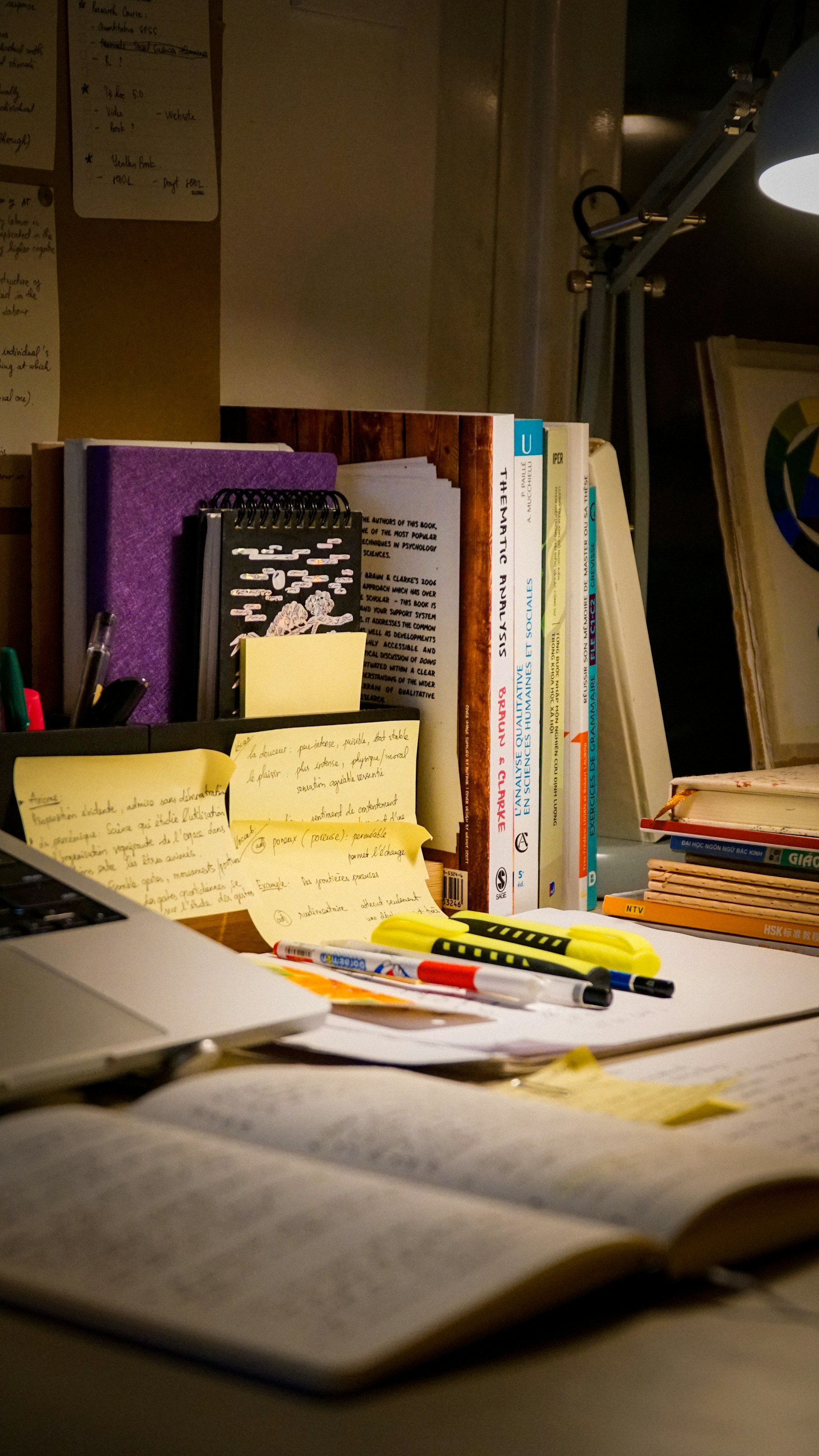 Research books, notes and study materials on a desk
